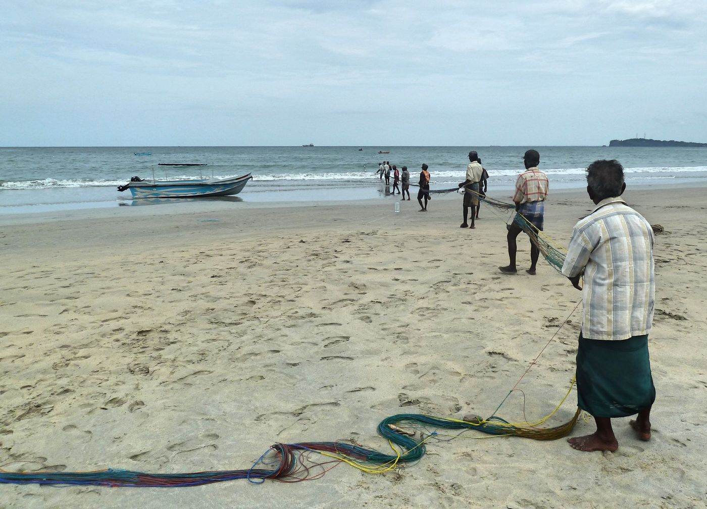 Fishermen hauling a net on a Sri Lankan beach
